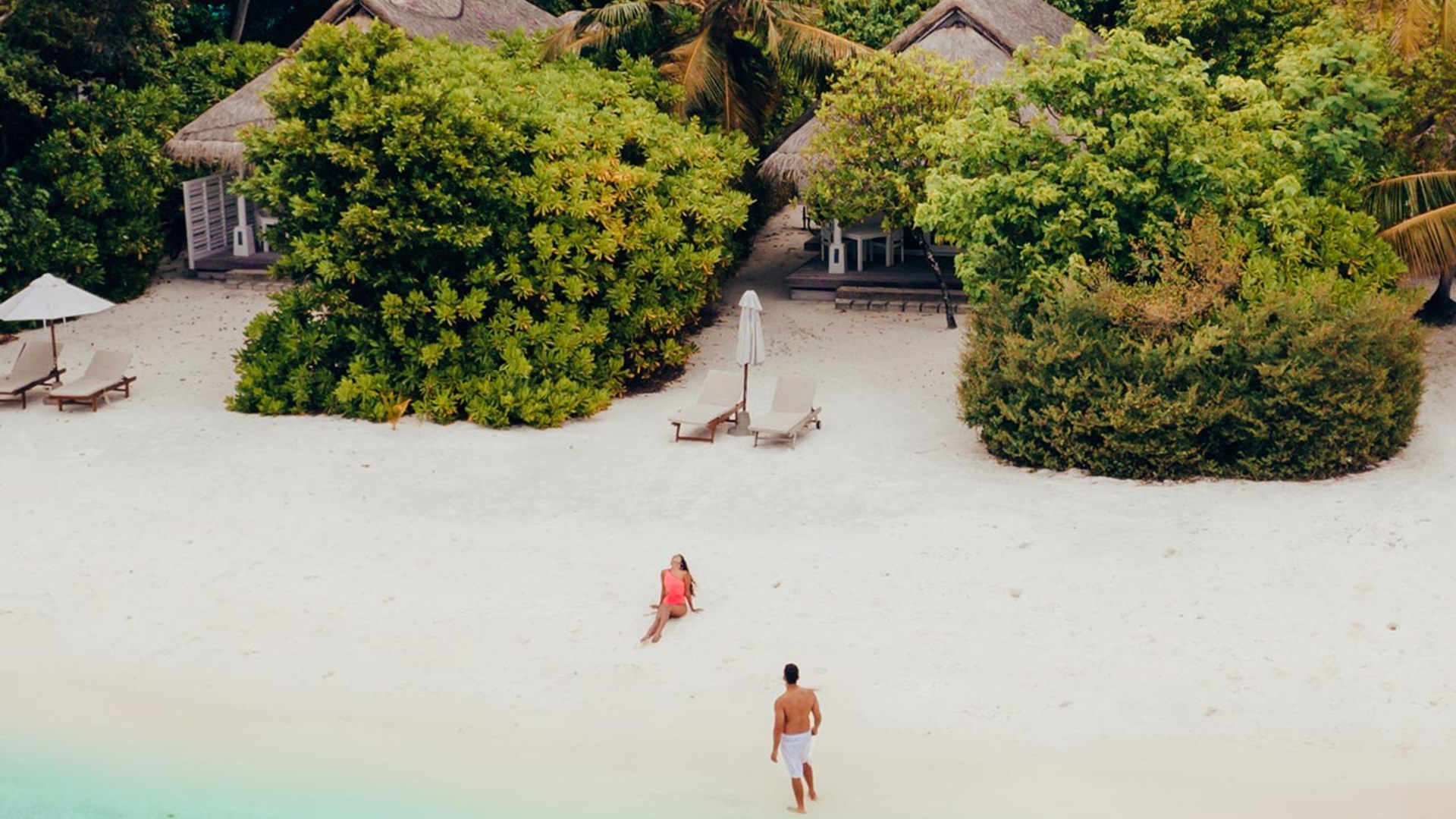 Couple on the beach in front of Beach Villas, LUX* South Ari Atoll