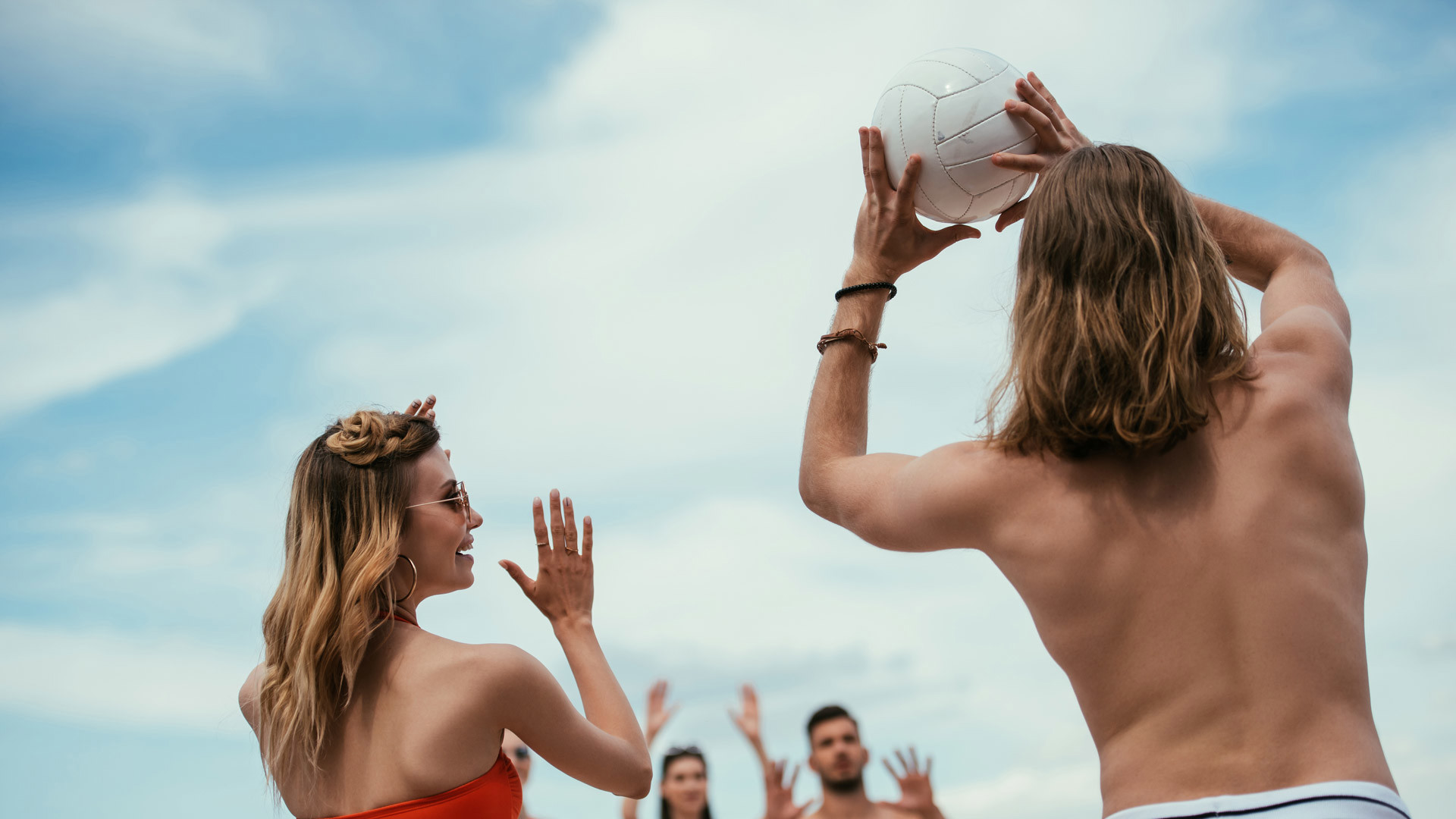 A group of friends playing beach volleyball