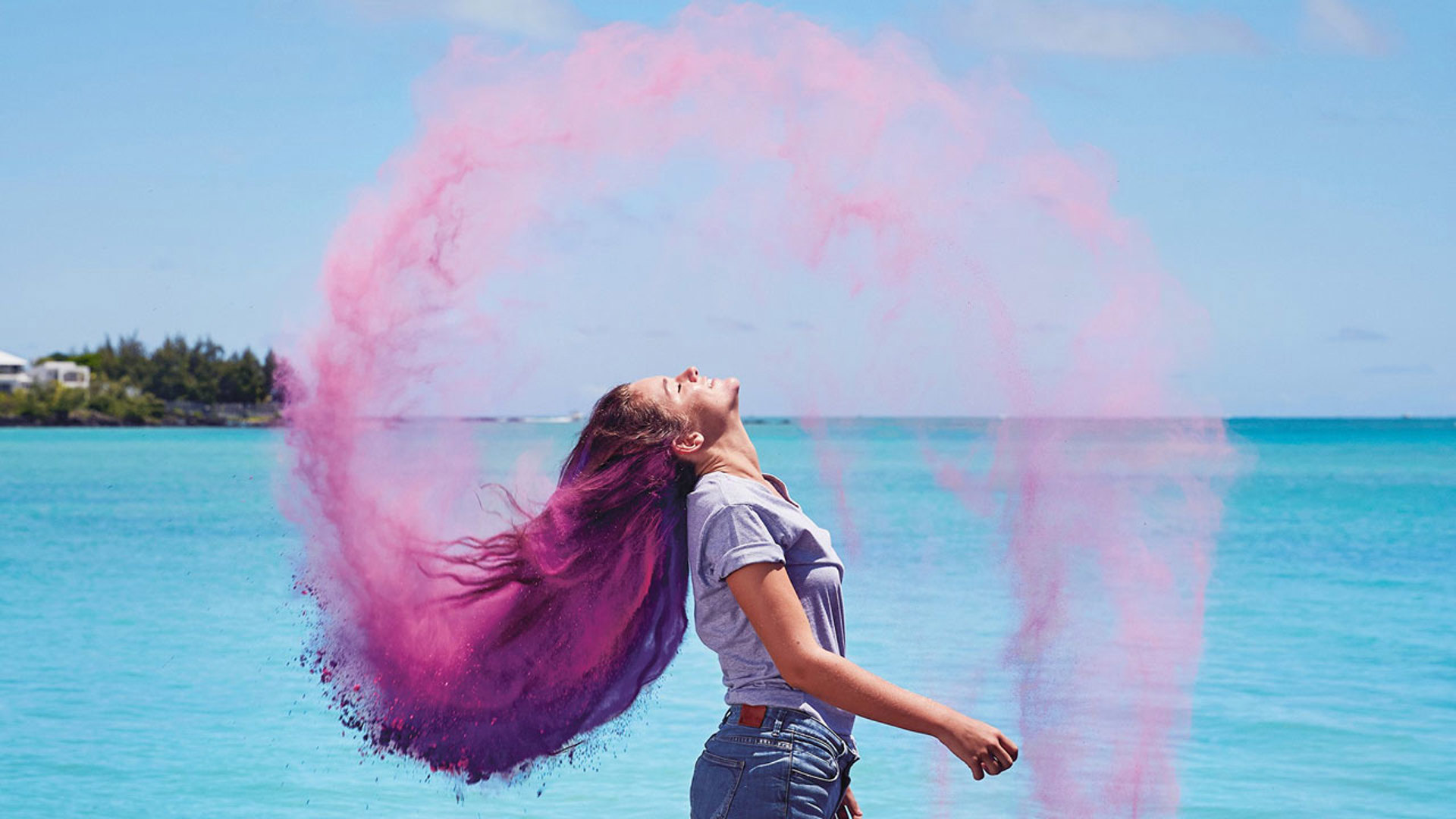 Woman with pink hair on the beach