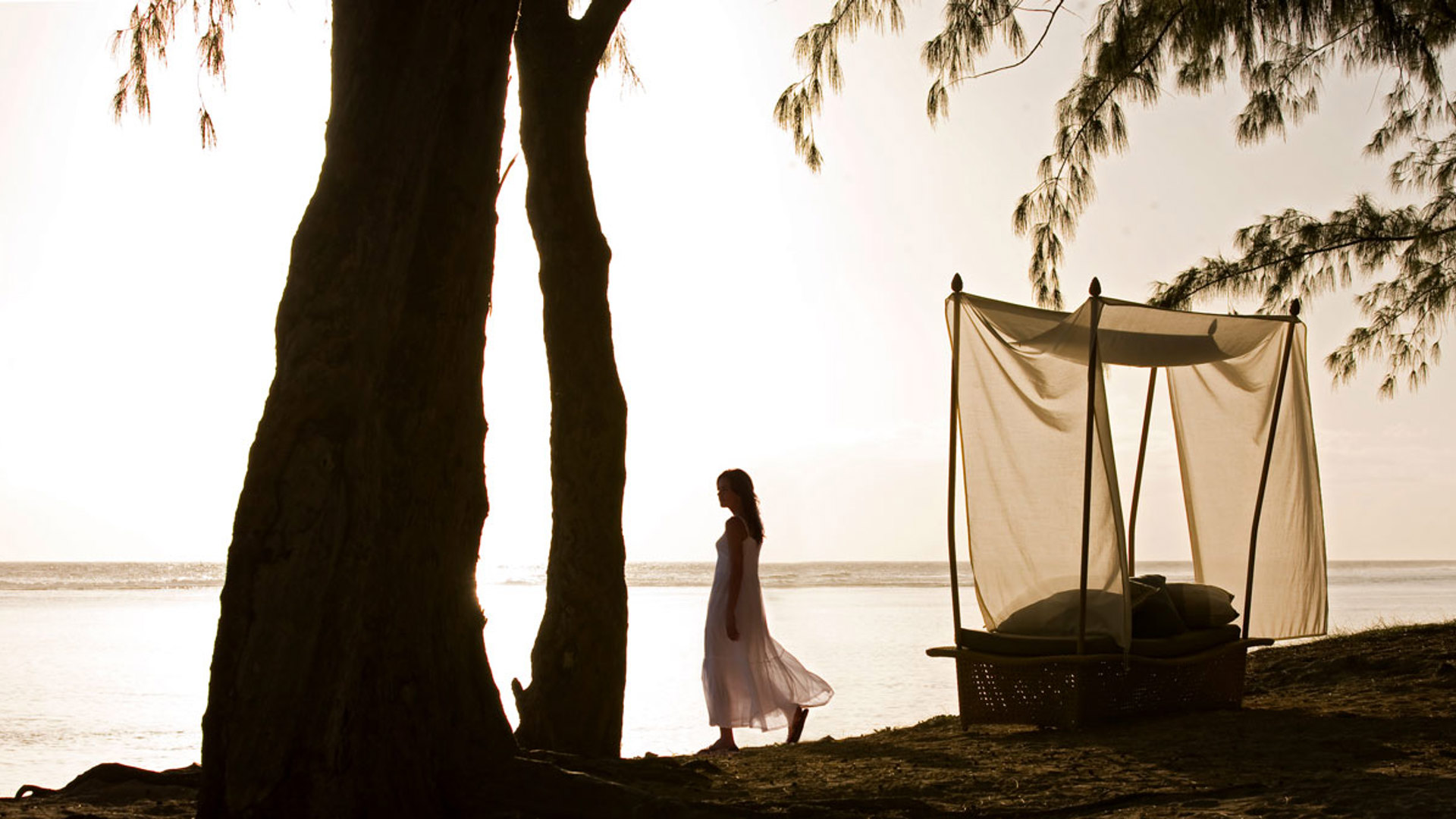 Woman walking on the beach of Saint Gilles Les Bains